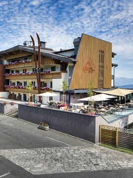 Hotel with panoramic terrace and flower balconies by the forest edge        Ask ChatGPT