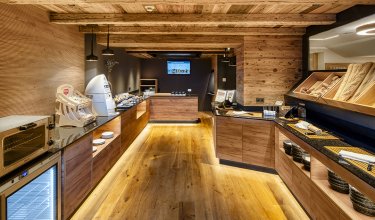 Breakfast area with bread selection and buffet in rustic wood design        Ask ChatGPT