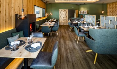 Elegant dining area with fireplace and stylish wood and green tones
