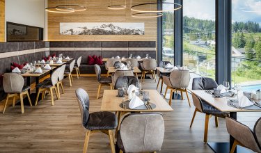 Modern restaurant with panoramic windows and elegantly set tables