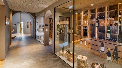 Hallway with view of modern wine cellar and bottle display