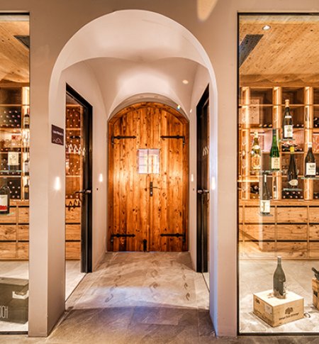 Atmospheric wine cellar with glass front and wooden shelves