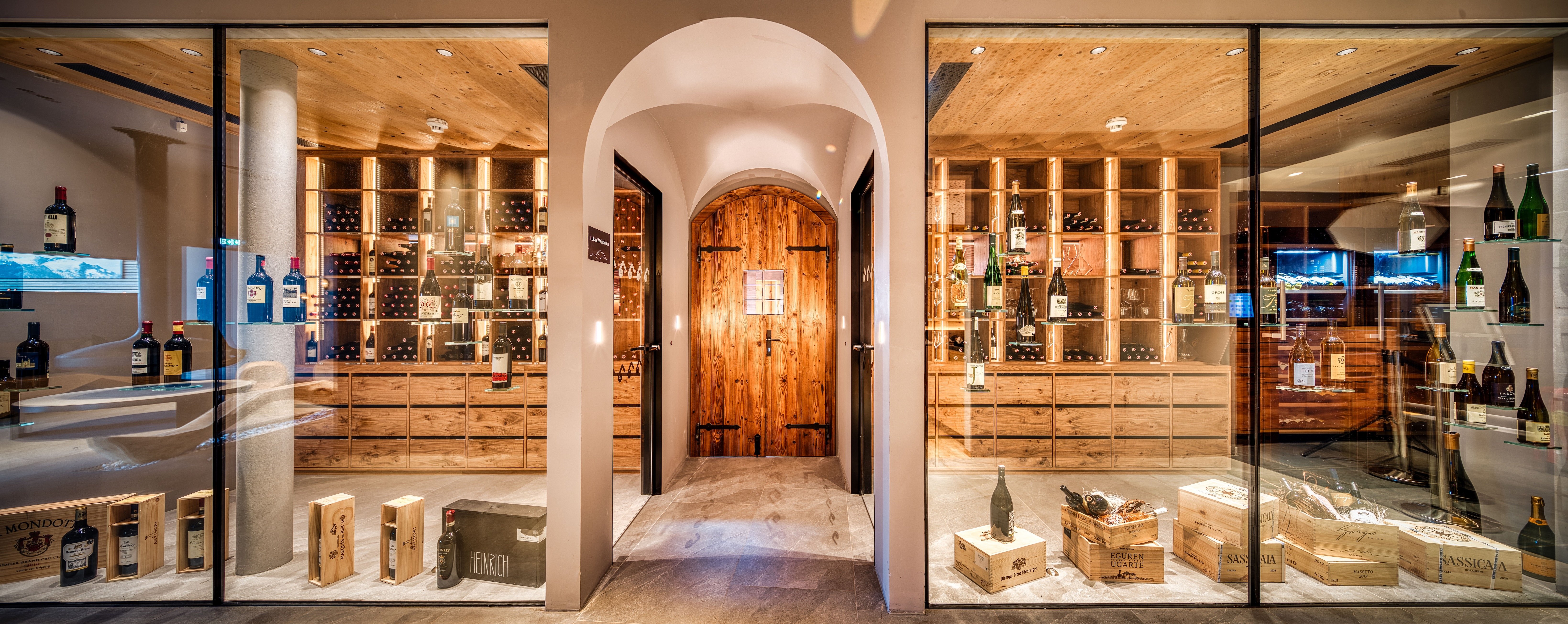 Atmospheric wine cellar with glass front and wooden shelves