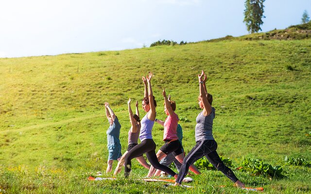 Yogapose beim Kurs in der wunderschönen Natur am Berg