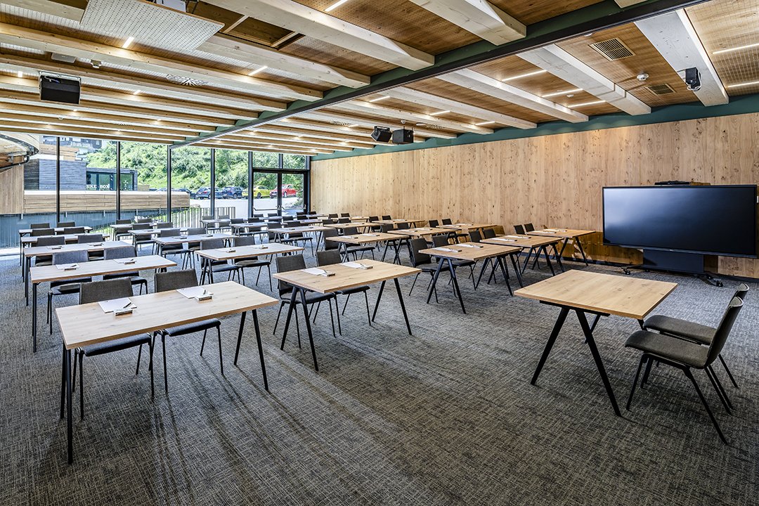 Bright seminar room with wooden ceiling, large windows and screen